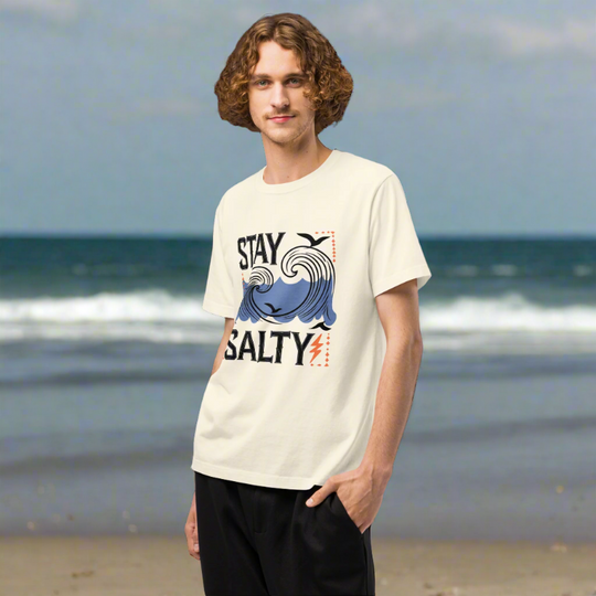 Person wearing a 'Stay Salty' t-shirt on a beach